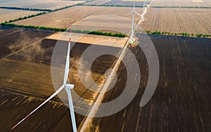 Aerial view of air turbines in a cultivated wheat field in a stopped position