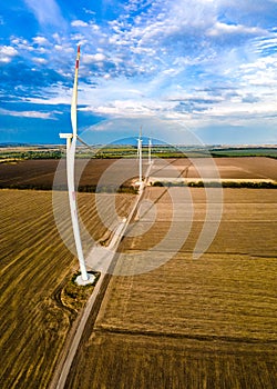 Aerial view of air turbines in a cultivated wheat field in a stopped position