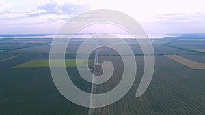 Aerial view of air turbines in a field near the coast