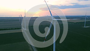 Aerial view of air turbines in a stopped position in a cultivated field