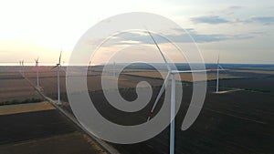 Aerial view of air turbines in a stopped position in a cultivated field