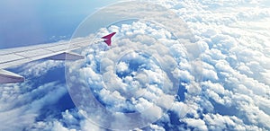 Aerial view of Aircraft or Airplane wing flying on sky and beautiful white clouds