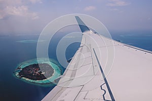 Aerial View from Aircraft Window to the Male Island among the Blue Indian Ocean