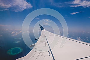 Aerial View from Aircraft Window to the Male Island among the Blue Indian Ocean