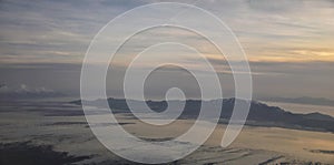 Aerial view from airplane of Antelope Island at sunset, view from Magna, sweeping cloudscape at sunrise with the Great Salt Lake