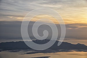 Aerial view from airplane of Antelope Island at sunset, view from Magna, sweeping cloudscape at sunrise with the Great Salt Lake