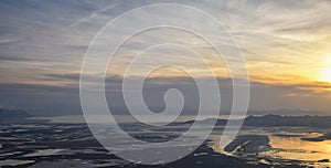 Aerial view from airplane of Antelope Island at sunset, view from Magna, sweeping cloudscape at sunrise with the Great Salt Lake