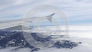 Aerial view from airplane. Flying over hill range with mist and fog in winter time, landscape, Italy