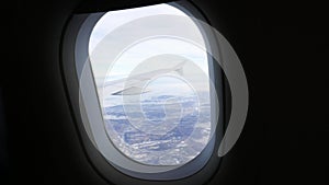 Aerial view from airplane. Flying over hill range with mist and fog in winter time, landscape, Italy