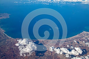 Aerial view from airplane during international flight. Travel in airplane, landscape from above and clouds