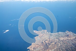 Aerial view from airplane during international flight. Travel in airplane, landscape from above and clouds