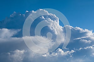 Aerial view from airplane of rain clouds and blue sky