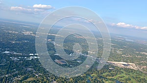 An aerial view from an airplane window of of St. Louis area with a view of the Mississippi River bright blue skies