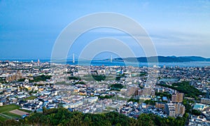 Aerial view of Akashi City and Awaji Island with bridge in distance at blue hour