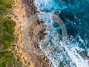 Aerial view of Alghero blue sea and rocky shore