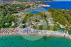 Aerial View of the Aliki Beach with colorful umbrellas, at Thassos island, Greece