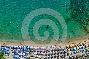 Aerial View of the Aliki Beach with colorful umbrellas, at Thassos island, Greece