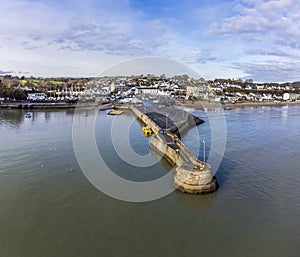 An aerial view along the harbour wall towards the village of Saundersfoot, Wales