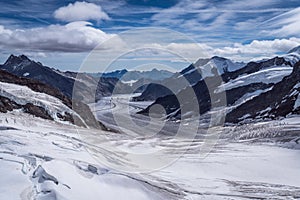 Aerial view of the Alps mountains in Switzerland. View from helicopter in Swiss Alps. Mountain tops in snow.