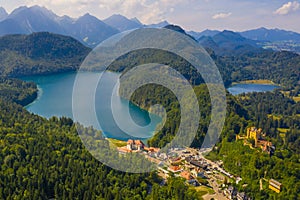 Aerial view on Alpsee lake and Hohenschwangau Castle, Bavaria, Germany. Concept of traveling and hiking in German Alps.