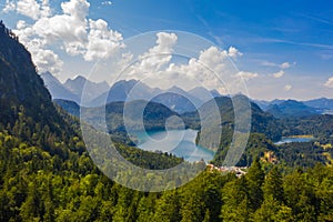 Aerial view on Alpsee lake and Hohenschwangau Castle, Bavaria, Germany. Concept of traveling and hiking in German Alps.