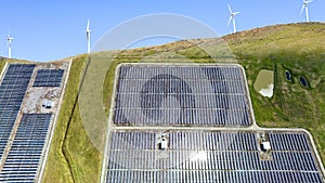 The aerial view Alternative clean energy while the solar panel, solar -with wind turbines generating electricity farm