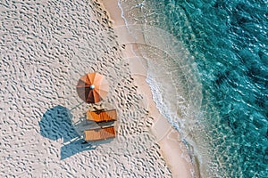 Aerial view of amazing beach with umbrella and lounge chairs beds close to turquoise sea