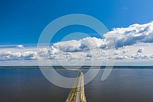 Aerial view of the amazing big river with dam under beautiful cloudy blue sky. Europe, Ukraine, Kremenchuk Reservoir, Dnieper or