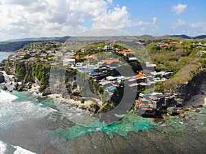 Aerial view of an amazing little surfer village on the rock cliff and coastline.