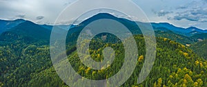 Aerial view amazing over of the Carpathian Mountains or Carpathians with Beautiful autumn landscape, sunrise, blue sky with white