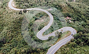 Aerial view of amazing road with green forest and mountain,Bird\'s eye view from drone