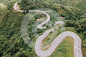 Aerial view of amazing road with green forest and mountain,Bird\'s eye view from drone