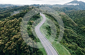 Aerial view of amazing road with green forest and mountain,Bird\'s eye view from drone