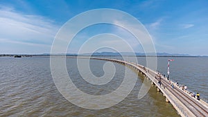 Aerial view of an amazing travel train parked on a floating railway bridge over the water of the lake in Pa Sak Jolasid dam with b