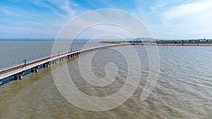 Aerial view of an amazing travel train parked on a floating railway bridge over the water of the lake in Pa Sak Jolasid dam with b