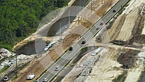 Aerial view of american highway under construction with moving traffic. Development of road infrastructure