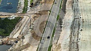 Aerial view of american highway under construction with moving traffic. Development of road infrastructure