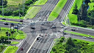 Aerial view of american wide multilane street intersection with traffic lights and moving cars and trucks. Concept of