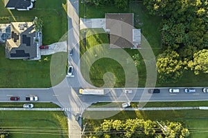 Aerial view of american yellow school bus picking up children at sidewalk bus stop for their lessongs in early morning