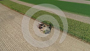 Aerial View of an Amish Family Farm Harvesting it`s Corn Crop on a sunny Autumn Day