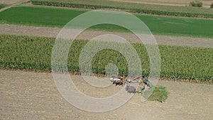 Aerial View of an Amish Family Farm Harvesting it`s Corn Crop on a sunny Autumn Day