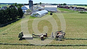 Aerial View of An Amish Farmer Harvesting His Crops With Three Horses Pulling is Crop Cutter