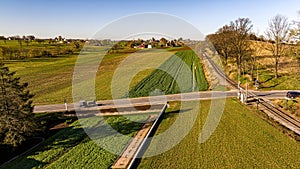 Aerial View of an Amish Horse and Buggy Traveling a Country Road Approaching a Rail Road Crossing