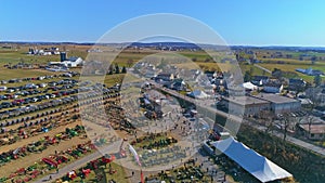 Aerial View of an Amish Mud Sale with Buggies, Farm Equipment and Other Crafts