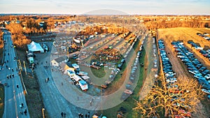 Aerial View of an Amish Mud Sale with Lots of Buggies and Farm Equipment