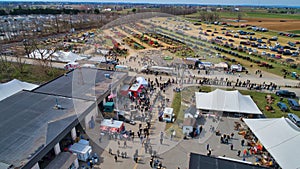 Aerial View of an Amish Mud Sale with Lots of Buggies and Farm Equipment