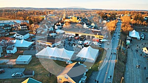 Aerial View of an Amish Mud Sale with Lots of Buggies and Farm Equipment