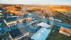 Aerial View of an Amish Mud Sale with Lots of Buggies and Farm Equipment