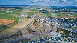 Aerial View of an Amish Mud Sale with Lots of Buggies and Farm Equipment