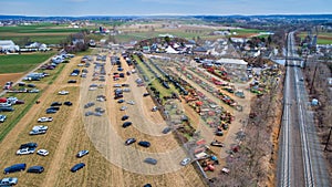 Aerial View of an Amish Mud Sale with Lots of Buggies and Farm Equipment